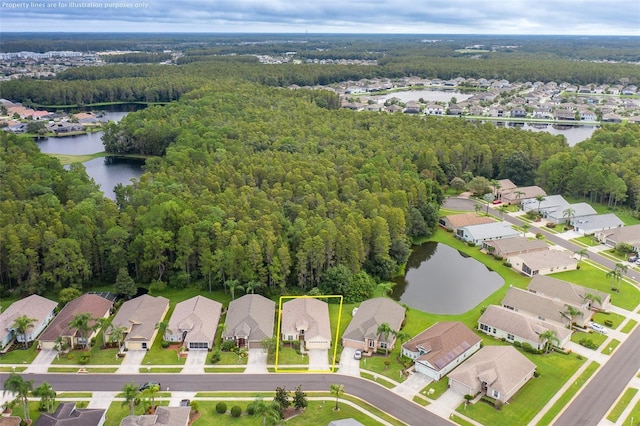 bird's eye view featuring a forest view, a residential view, and a water view