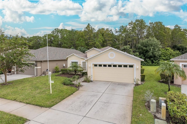 ranch-style home with stucco siding, a front lawn, a garage, and driveway