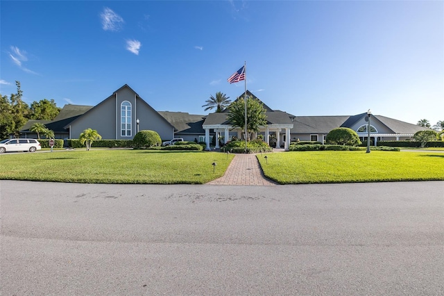 view of front facade with decorative driveway and a front yard