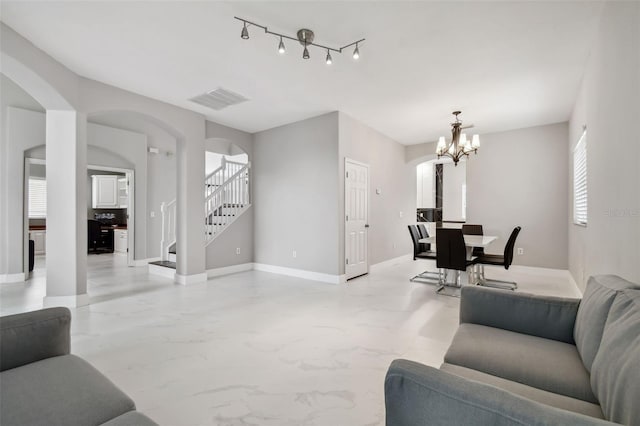 living room featuring a notable chandelier