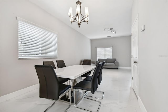 dining space with a notable chandelier