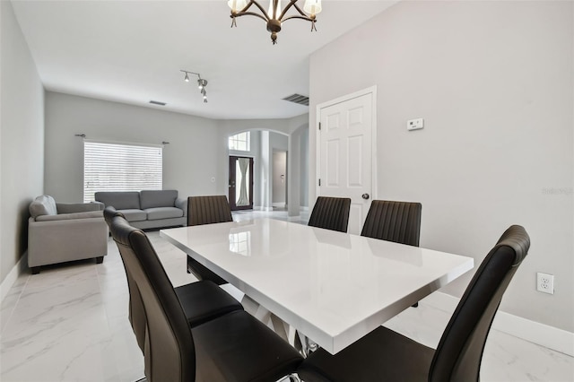 dining area featuring an inviting chandelier