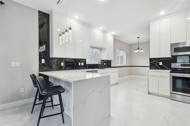 kitchen with pendant lighting, kitchen peninsula, white cabinetry, a kitchen breakfast bar, and stainless steel appliances