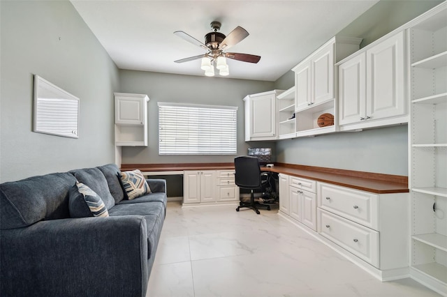 office area with ceiling fan and built in desk