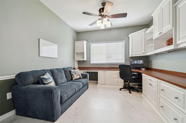 home office featuring built in desk and ceiling fan