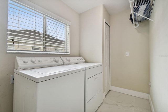 clothes washing area with washing machine and dryer