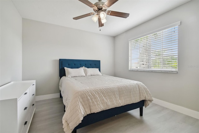 bedroom with ceiling fan and light hardwood / wood-style flooring