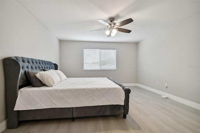 bedroom with ceiling fan and light hardwood / wood-style flooring