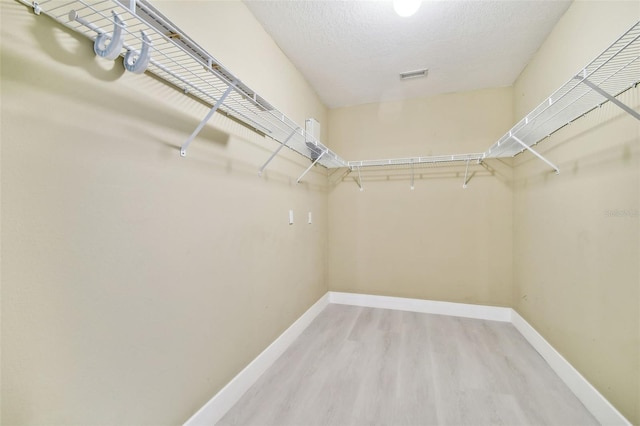 spacious closet featuring hardwood / wood-style flooring