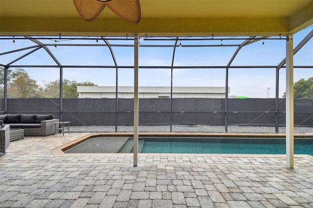 view of pool featuring ceiling fan, an outdoor hangout area, glass enclosure, and a patio