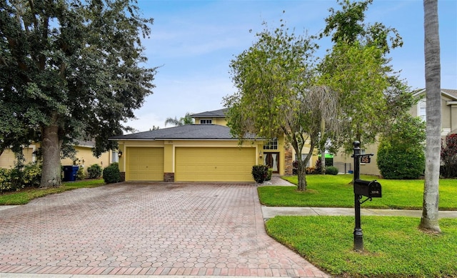 view of front of home featuring a front lawn and a garage