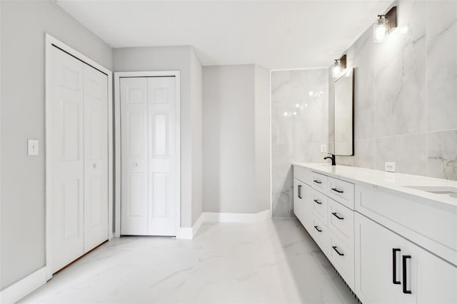 bathroom with tile walls and vanity