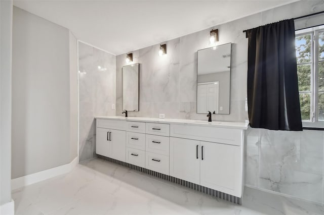 bathroom with vanity and tile walls