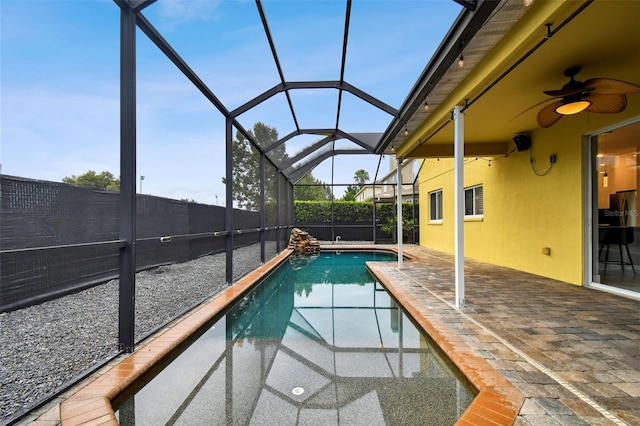 view of pool featuring a lanai, ceiling fan, and a patio area