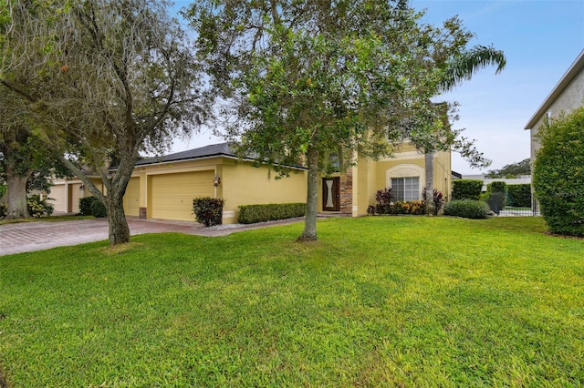 view of front of property with a garage and a front lawn