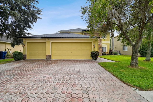 view of front facade with a front lawn and a garage