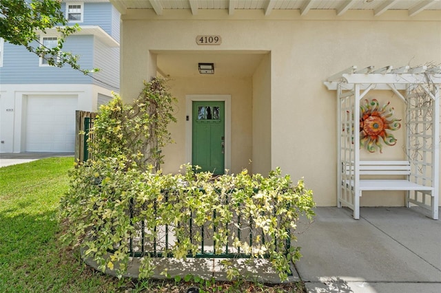 doorway to property with a garage