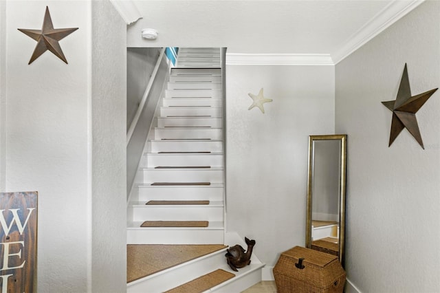 staircase featuring crown molding