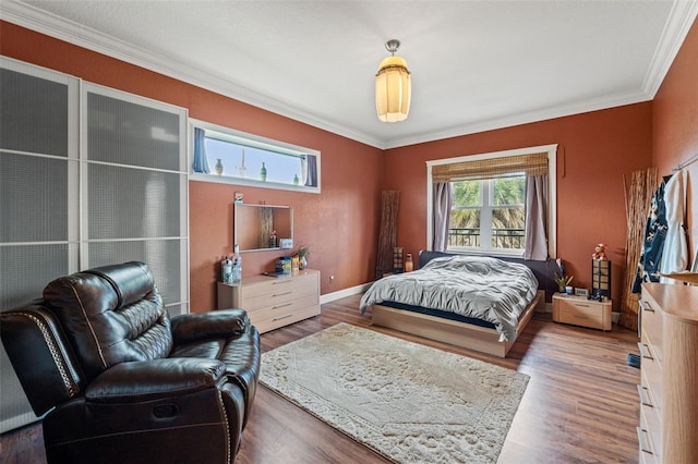 bedroom featuring wood-type flooring and crown molding