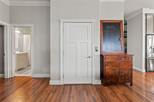 unfurnished bedroom featuring dark hardwood / wood-style floors, ensuite bathroom, stainless steel fridge with ice dispenser, and crown molding