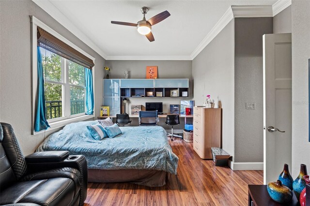 bedroom with ornamental molding, hardwood / wood-style floors, and ceiling fan