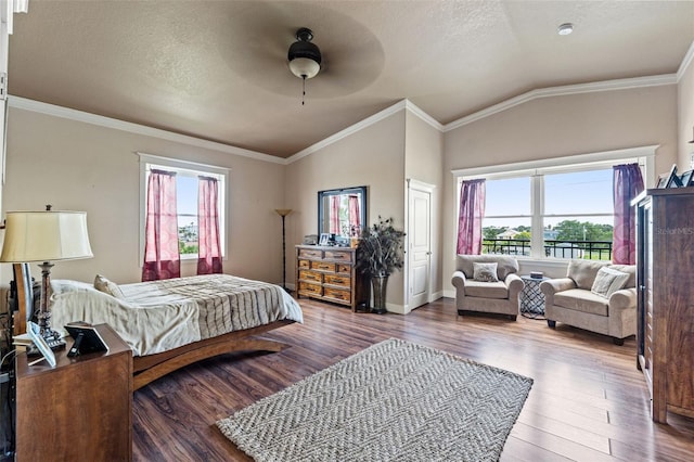 bedroom with ornamental molding, wood-type flooring, lofted ceiling, and ceiling fan