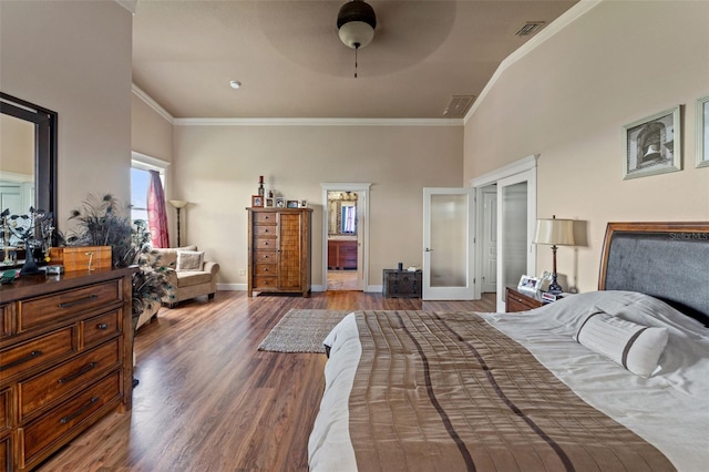 bedroom with ceiling fan, crown molding, and dark wood-type flooring