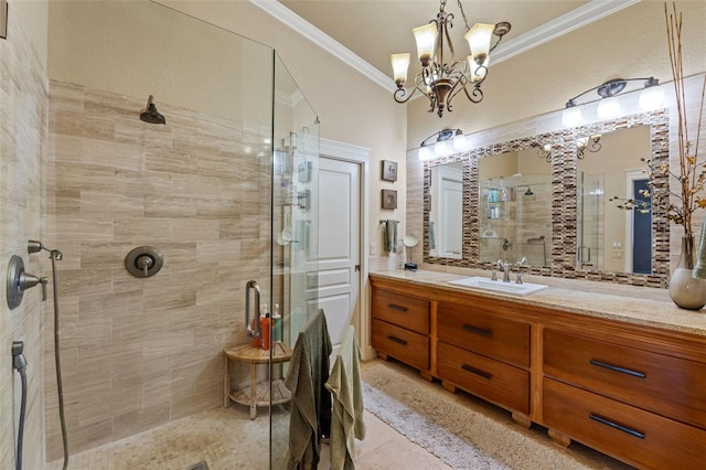 bathroom with vanity, a chandelier, ornamental molding, and a shower with door