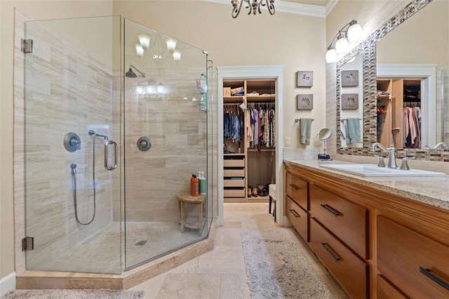 bathroom with walk in shower, vanity, and crown molding