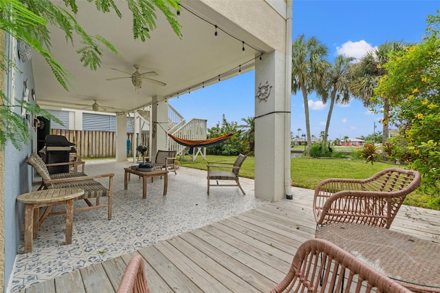 deck featuring a lawn and ceiling fan