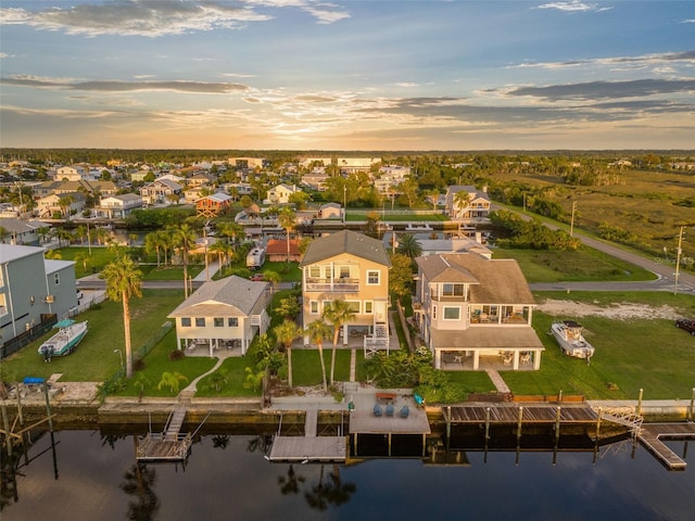 aerial view at dusk with a water view