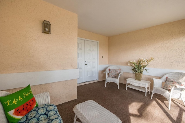 living area with dark colored carpet