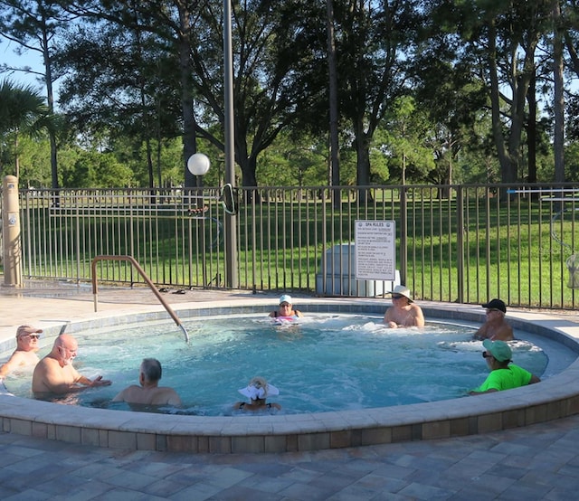 view of pool with a lawn