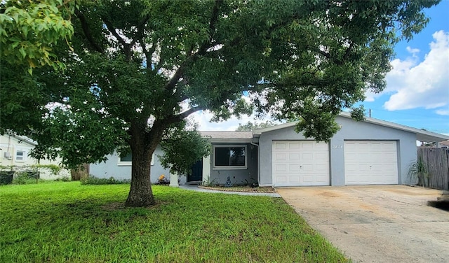 ranch-style house with a garage and a front lawn