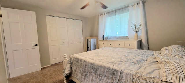 carpeted bedroom with ceiling fan and a closet