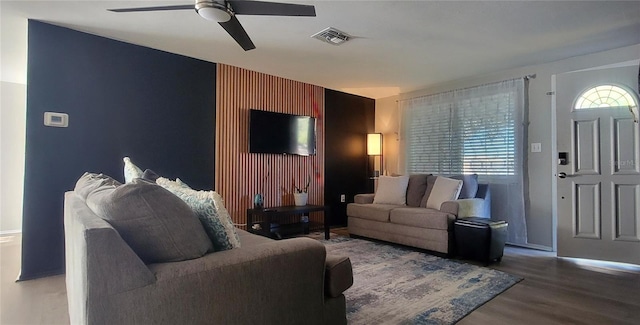 living room featuring hardwood / wood-style flooring and ceiling fan