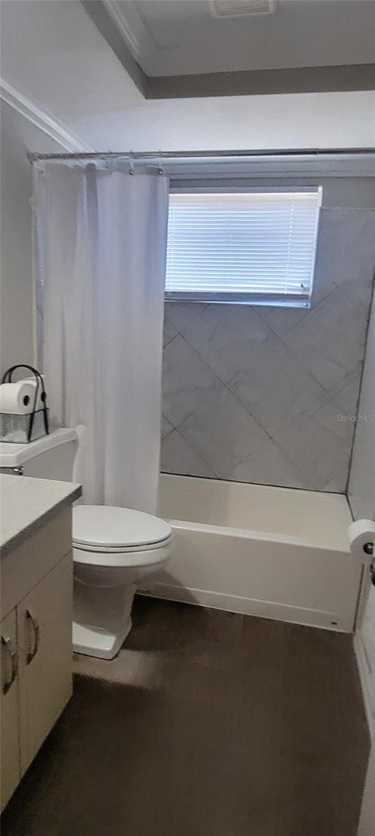 full bathroom with shower / bathtub combination with curtain, vanity, and toilet