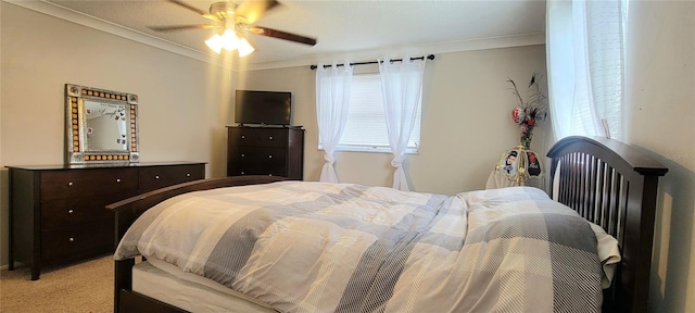 bedroom featuring ceiling fan, crown molding, and light carpet