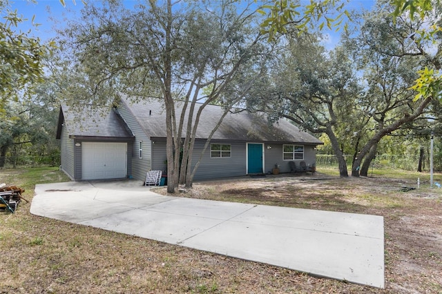 ranch-style house with a garage and a front yard