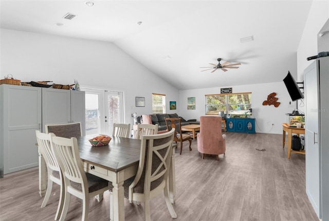 dining area with lofted ceiling, plenty of natural light, ceiling fan, and light hardwood / wood-style floors