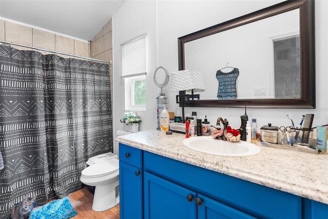 bathroom with vanity, walk in shower, toilet, hardwood / wood-style flooring, and lofted ceiling