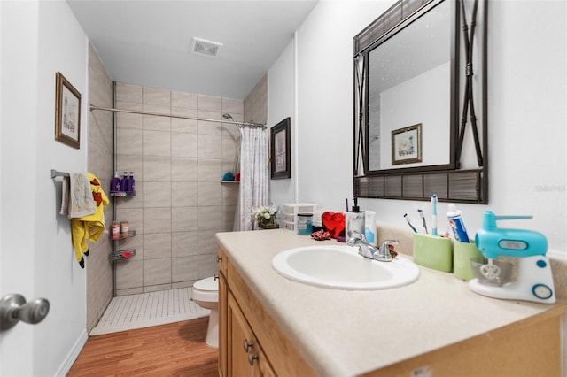 bathroom with vanity, toilet, a shower with shower curtain, and hardwood / wood-style floors