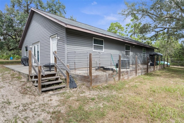 back of property featuring a wooden deck and central AC unit