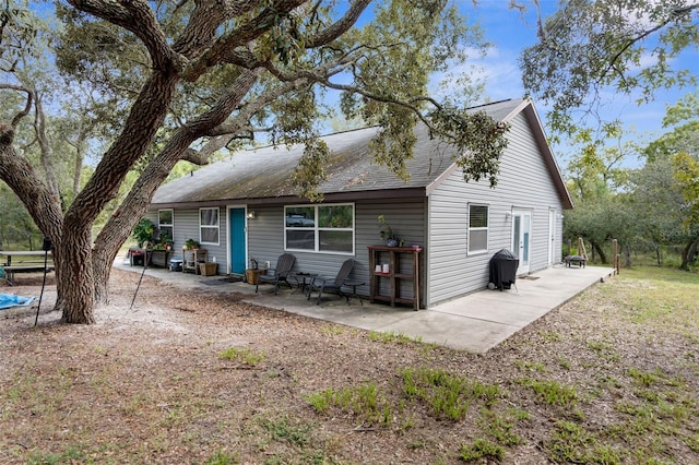 back of property with a patio