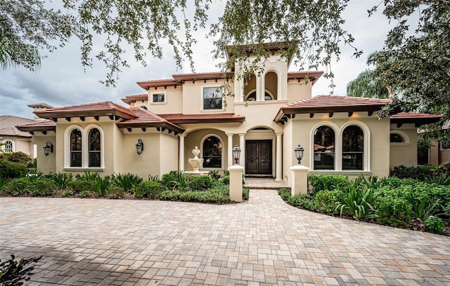 9943 Milano Dr, Trinity, FL 34655 - mediterranean / spanish home with stucco siding and a tile roof