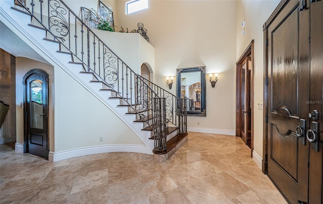 9943 Milano Dr, Trinity, FL 34655 - entrance foyer with baseboards, a towering ceiling, and stairway