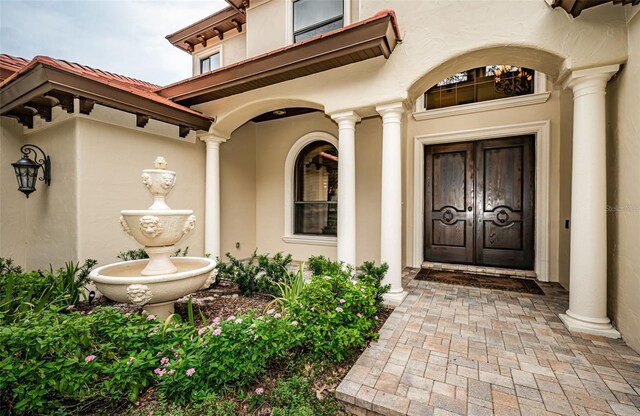 9943 Milano Dr, Trinity, FL 34655 - entrance to property featuring stucco siding