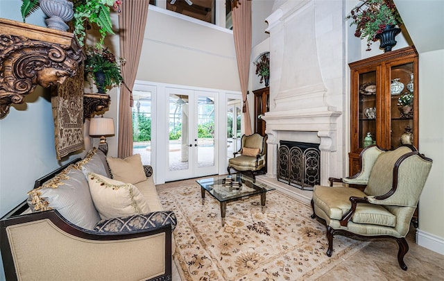 living room with a towering ceiling, french doors, and light tile patterned flooring