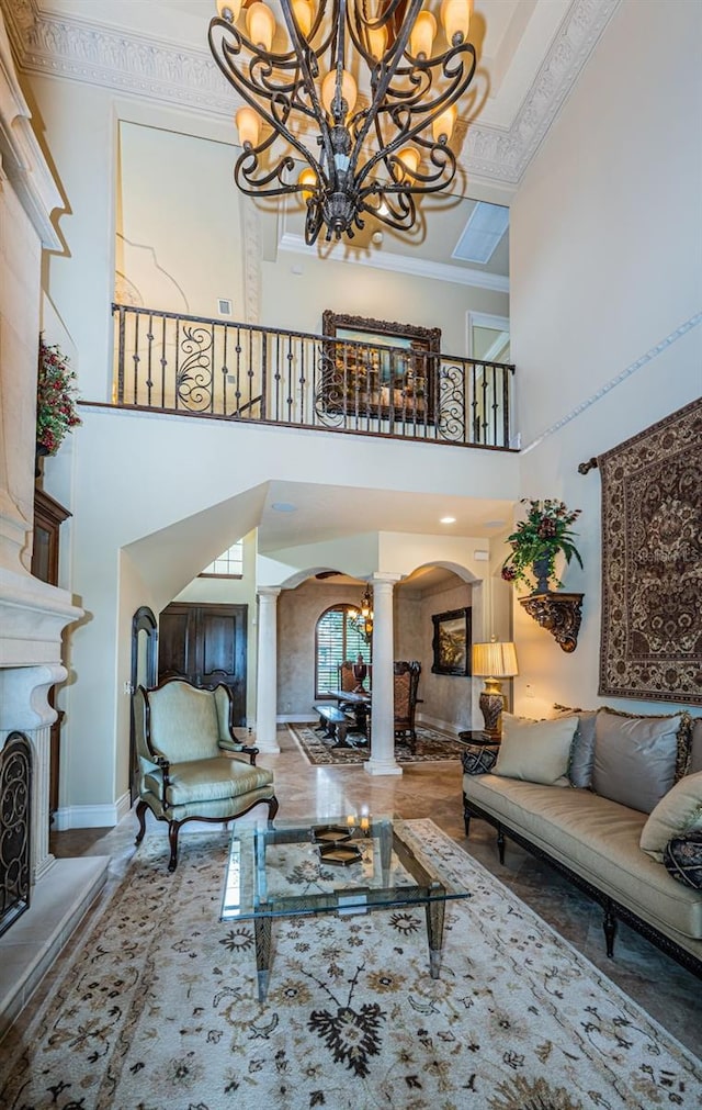 9943 Milano Dr, Trinity, FL 34655 - living area with crown molding, ornate columns, baseboards, a chandelier, and arched walkways