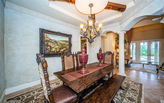 dining room featuring an inviting chandelier, french doors, and ornate columns